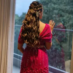 A hairstyle should be a work of art. This intricate combination of braids and soft curls not only looks beautiful from the back but is also designed to stay perfect through a night of dancing.