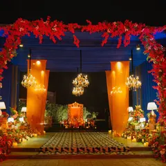 First impressions are everything. I designed this grand entrance with a stunning red floral arch, dramatic uplighting, and sparkling chandeliers to welcome guests into an evening of pure celebration and luxury.