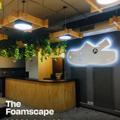 The reception at the Crocs headquarters in Gurugram, which we named 'The Foamscape'. We brought the brand's playful identity to life with a custom illuminated logo, suspended greenery, and warm wood finishes, creating a space that is both fun and functional.
