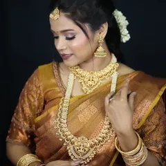 A classic South Indian bridal look. The makeup is kept warm and golden to match the traditional gold jewelry and the rich texture of the silk saree.