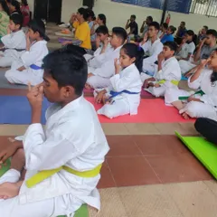 Here, my students are practicing Nadi Shodhana (alternate nostril breathing). This pranayama technique is used to calm the nervous system and improve concentration before and after intense training.