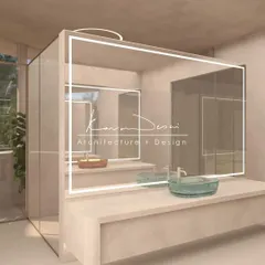 We created a sense of quiet symmetry in this bathroom by placing two basins opposite each other. The design plays with perspective and flow, while the LED-backlit mirrors add a modern touch.