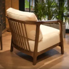 A view of the armchair's slatted back, a classic design element that provides both support and visual interest. The craftsmanship is evident in every smooth, curved line of the wooden frame.