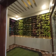 A wider view of the vertical garden installation in a semi-outdoor space. It transforms a plain wall into a living feature, creating a resort-like feel at home.