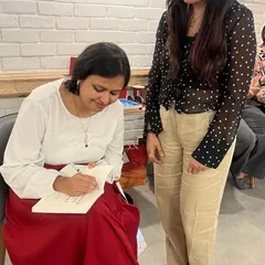 The best part of any author meet: getting your book signed. It’s a personal touch that readers cherish, and we make sure there's plenty of time for these special moments. Here, Smita Das Jain signs a copy for a happy reader.