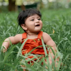 Exploring the tall grass with a big smile. We love capturing these moments of pure, unscripted joy.
