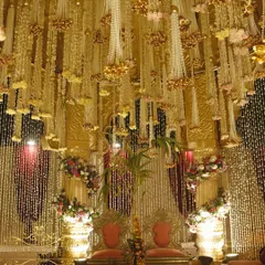 The view from within the mandap, where the couple is surrounded by a ceiling of cascading floral and pearl strings. This detail ensures that every angle is breathtaking, both for the couple and in their wedding photos.