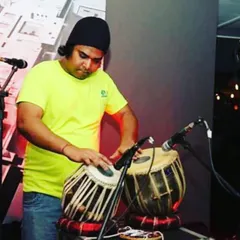 A candid shot from a live fusion gig. The casual attire and stage setup reflect the modern, experimental nature of these performances where I mix tabla with different genres.