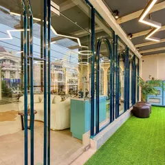 A look from the balcony into the bright, open studio space. The design uses glass and light to create an energizing and inspiring environment for your workout.