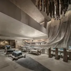 For the La Solitaire jewellery showroom, I wanted to create a space that felt like discovering treasure within the earth. This view shows how we used a driftwood chandelier, sculptural stone seating, and fluid, cave-like walls to craft a retail experience that is about contemplation and raw, natural luxury.