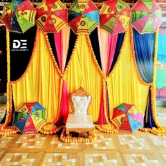 This vibrant Mehendi setup is all about celebrating with color and tradition. I used bright yellow and blue drapes, traditional Rajasthani umbrellas, and marigold garlands to create a festive and joyful atmosphere for the ceremony.