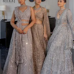 Three models showcase the versatility of silver and gold, each wearing a unique lehenga from the 'Ruvaah' collection, perfect for a coordinated bridal party.