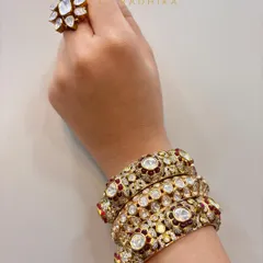 A beautiful stack of ruby and polki kadas, paired with a matching floral polki ring. This shows how to create a cohesive look for your hands.