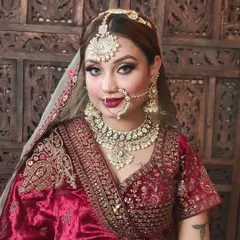 This image showcases a full bridal set with a heavy Kundan choker, matching earrings, a large maang tikka, and a classic nath. We can adjust the size and details of each piece.
