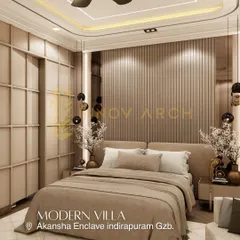 This modern bedroom design from the Akansha Enclave villa uses a warm, earthy palette. The fluted wooden paneling behind the bed and the contemporary wardrobe design add texture and sophistication to the space.