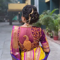 The complete look from the back, showcasing the intricate bun, the traditional accessories, and how it all complements the stunning blouse design.