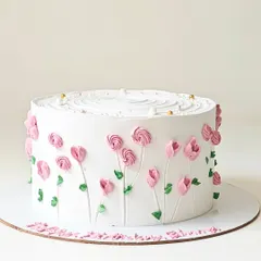 A simple white cake adorned with delicate pink buttercream tulips. This minimalist design focuses on clean lines and the beauty of hand-piped floral art.