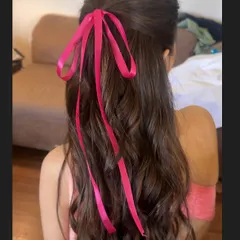 A simple yet chic half-updo with soft waves, tied together with a bright pink satin ribbon. This playful and youthful style is perfect for a fun pre-wedding event like a bridal shower or Mehendi.