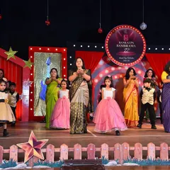 A beautiful stage moment with girls in flowing pink and yellow gowns, designed to create a graceful and unified look for their school event.
