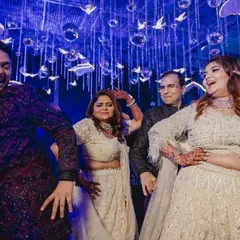 Get ready to groove, it's Sangeet time. A candid shot of the couple and their family enjoying the party.