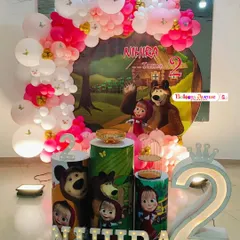 A fun and adventurous Masha and the Bear themed party for Nihira's second birthday. The decorations feature a forest backdrop and props with the beloved characters.