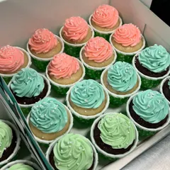 Adorable pink and teal cupcakes for a baby shower. These simple swirls with a sprinkle of white nonpareils are perfect for celebrating a new arrival.