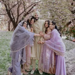 The bond between a groom and his sisters is special. This candid photo captures a moment of pure joy and affection, a memory that the family will cherish forever.