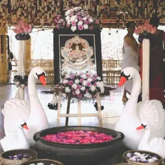 An elegant decor detail from one of our weddings. The swan figures, symbolizing purity and grace, along with bowls of floating flowers, add a touch of divine beauty to the entrance of the wedding venue.