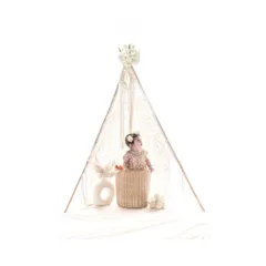 A wider view shows the baby in her basket, framed by a macrame teepee. This beautifully styled studio shot has a modern, bohemian feel, perfect for a unique first birthday session.