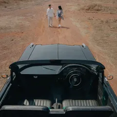 A vintage car adds a touch of classic romance to this Goa pre-wedding shoot. We love incorporating unique props that tell a story of adventure and style.