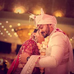 An emotional and tender hug between the bride and groom right after the varmala exchange.