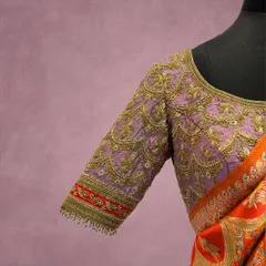A close-up of a lavender blouse sleeve, adorned with scalloped patterns in gold zardozi work. This design is inspired by the intricate patterns found in traditional Indian jewelry, transforming the blouse into a wearable work of art.