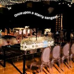 The 'Starry Sangeet' theme was born from the couple's love for the cosmos. The guest seating featured mirrored tables reflecting a ceiling of countless fairy lights, making everyone feel like they were dining under the stars.