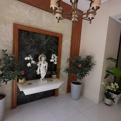 Plants are perfect for creating a serene and welcoming entryway or pooja space. Here, I've used elegant potted orchids and flowering plants to frame a beautiful statue, adding a sense of peace and respect.
