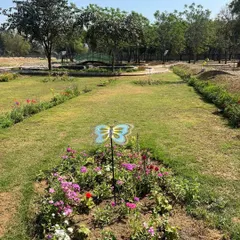 A view of a flower bed within the Butterfly Park, complete with a decorative butterfly marker. We planted a specific mix of nectar-rich flowers to create a welcoming habitat.