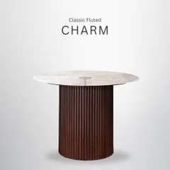 This round dining table with a fluted base is a piece of classic charm. It's perfect for intimate gatherings and serves as a stunning centerpiece for any dining space.