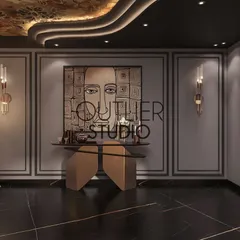 This entertainment area combines art and design, with a unique console table, modern wall sconces, and a statement art piece creating a sophisticated and moody atmosphere for intimate gatherings.