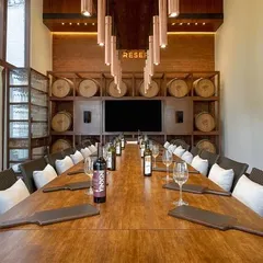 Our 'Cave de la Reserve' offers an enchanting space for private tastings and events. The long table, set against a backdrop of wine barrels, creates a vintage masterpiece atmosphere for any gathering.