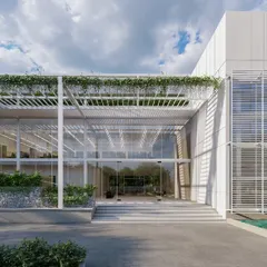 The entrance to the MOSPO office building in Bangalore demonstrates our vision for modern workplaces. We integrated extensive glazing, clean structural lines, and natural elements like water features and climbing greenery to create a transparent, light-filled, and inspiring environment for creativity and collaboration.