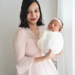 A mother's gentle hold. This portrait showcases the serene bond between mother and newborn, framed with soft, natural lighting for a dreamy and classic look.