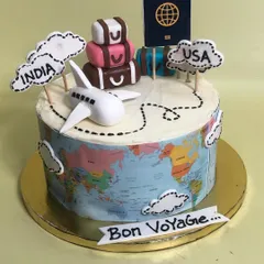 A 'Bon Voyage' cake perfect for someone embarking on a new journey. This travel-themed cake features an edible world map wrap, a fondant passport, luggage, and an airplane charting a course from India to the USA.