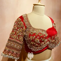 The front view of Bhavya's blouse, showcasing the intricate embroidery of zardosi, beads, and pearls that frame the silhouette.