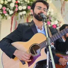 Lost in the moment during a wedding performance. I love creating a soulful atmosphere with my guitar, perfect for the more intimate parts of the celebration.