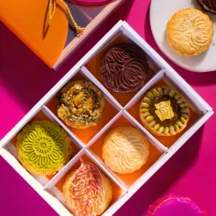 A glimpse inside one of my modern festive gift boxes. Each compartment holds a unique creation, from gold-dusted pumpkin fudge tartlets to intricately molded chocolate biskuts, offering a journey of reinvented Indian flavors.