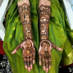 This design tells a complete wedding story on the arms. It includes portraits of the couple, scenes from the varmala ceremony, and other traditional wedding symbols.