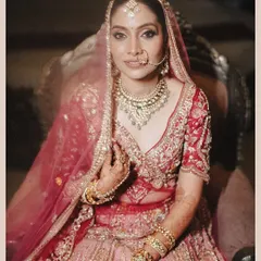 A classic, seated bridal portrait of Aditi. This shot captures her regal poise and the intricate details of her jewelry and makeup, making her look like a true maharani.