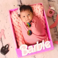 A real-life doll! This 'Barbie' themed shoot is perfect for your little fashionista, complete with a pink box, tiny accessories, and a whole lot of style.