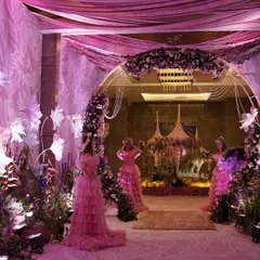 An entrance designed to feel like walking through a dream. I crafted this immersive floral tunnel with oversized paper flowers, soft drapes, and ethereal lighting to set a whimsical tone for the ring ceremony.