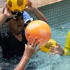 Fun and games with a friendly match of water polo. Activities like these help improve water confidence, teamwork, and agility in a playful way.