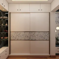 A closer look at the sliding wardrobe with a serene floral pattern. The loft cabinets above provide extra storage, maximizing the use of vertical space.